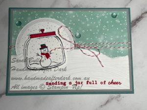 Festive handmade Christmas card featuring a jar, flowers, and Lost Lagoon accents.
