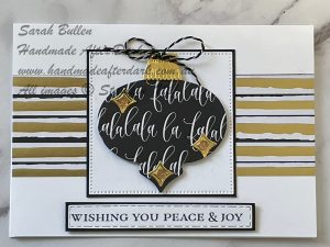 Elegant handmade Christmas card with black, white, and gold elements, modern style, and festive details.