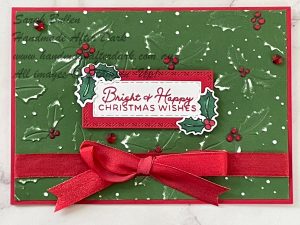 Handmade Christmas card with embossed two-tone red and green cardstock using Jolly Holly bundle