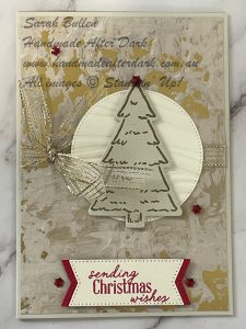 Christmas card with heat embossed pine trees and festive accents on beige background