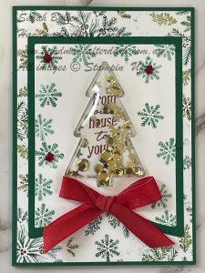 Festive Christmas shaker card featuring pine trees, snowflakes, and gold shaker elements.