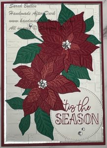 card with large poinsettias and grene leaves on white background